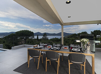 Althoff Villa Belrose in St. Tropez Côte d'Or Terrasse mit gedecktem Tisch und Stühlem mit Meerblick im Sommer
